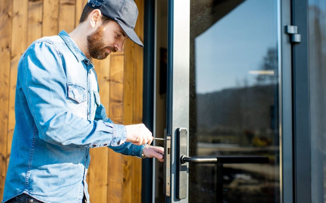 A man fixes his entry door lock