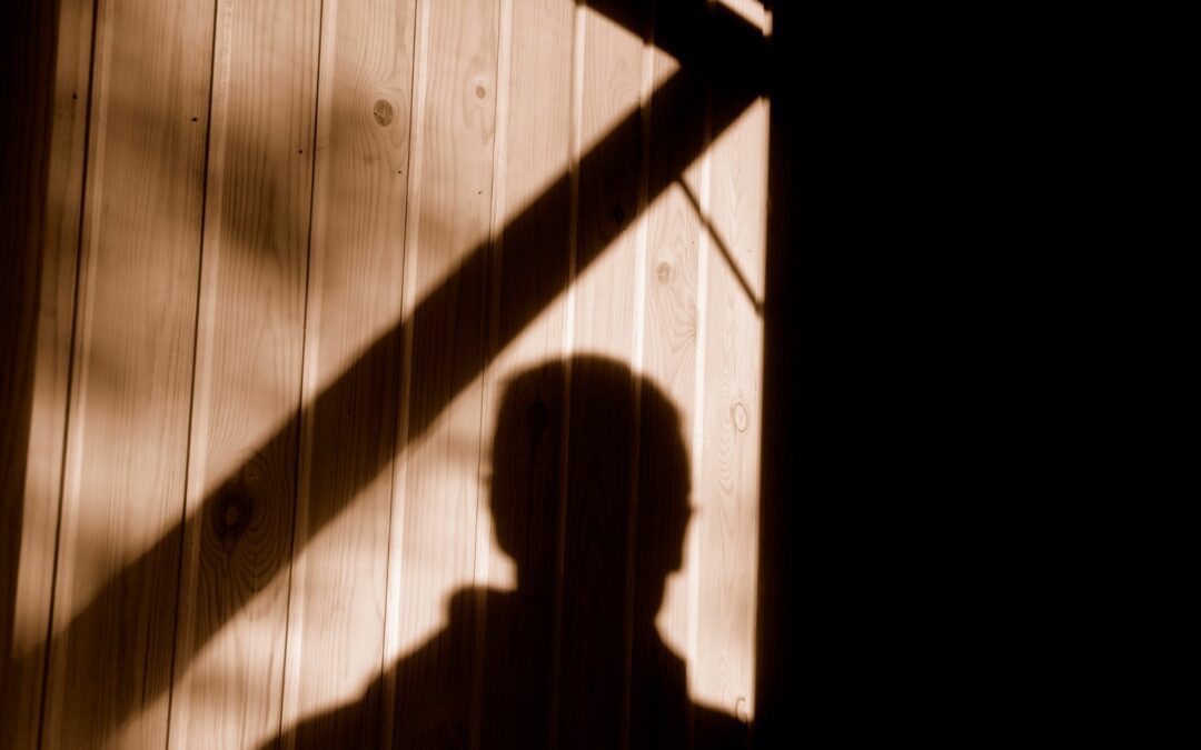 A burglar's shadow on the property of someone who didn't know the signs a burglar is casing your home