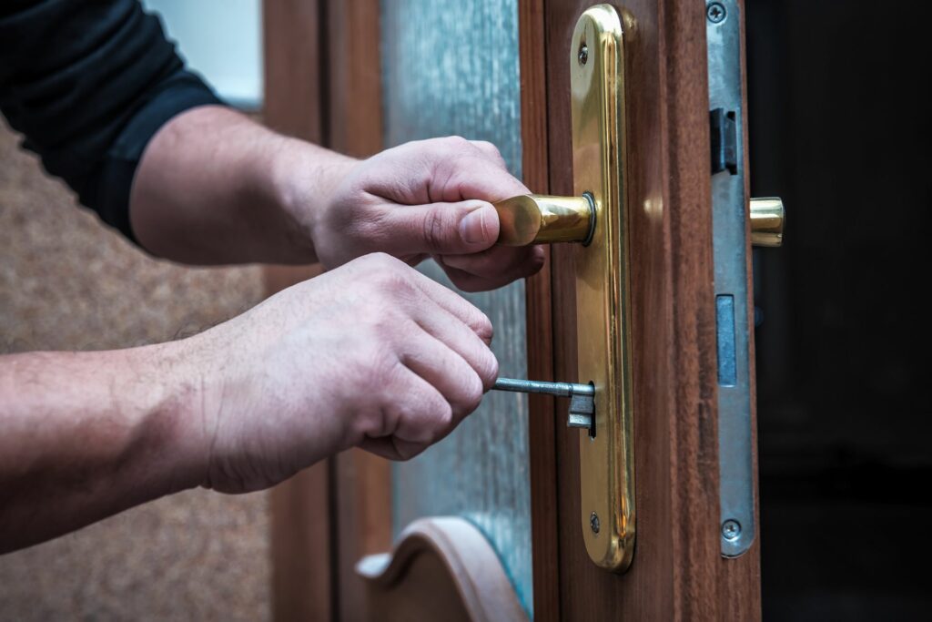 A locksmith installs one of the best lock brands for a homeowner