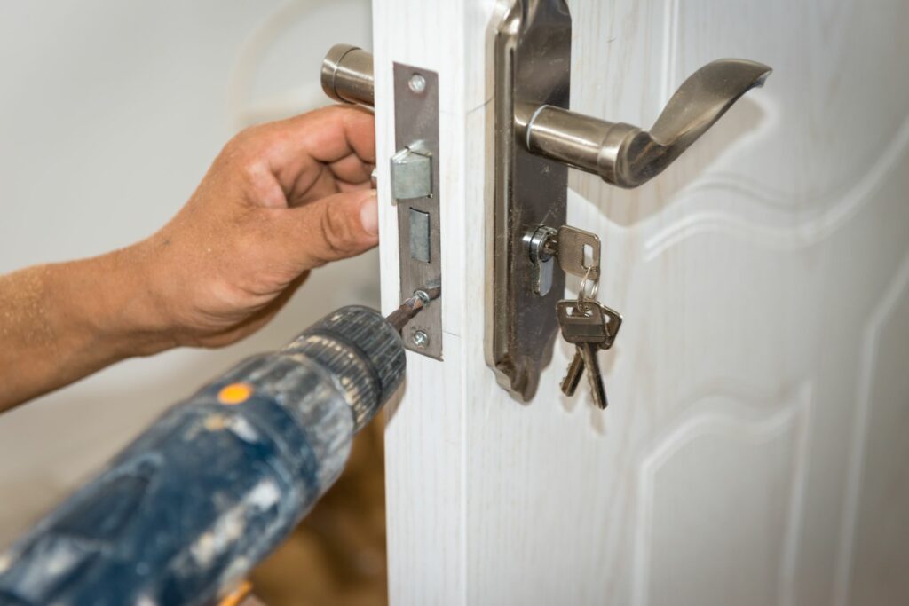 A professional helps a homeowner with lock replacement.
